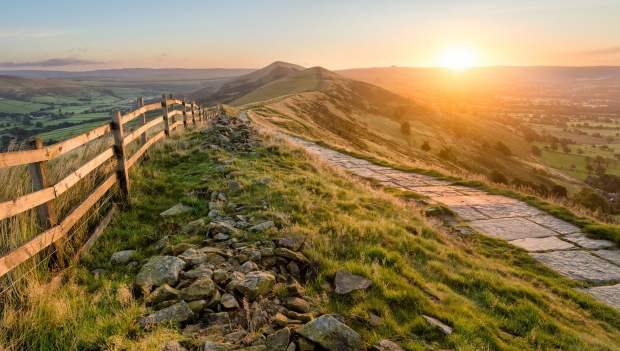 image of a hill with a footpath and fence on the left.