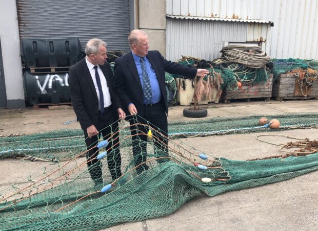 Image showing Agricultural and Fisheries Minister Robert Goodwill inspects a large fishing net