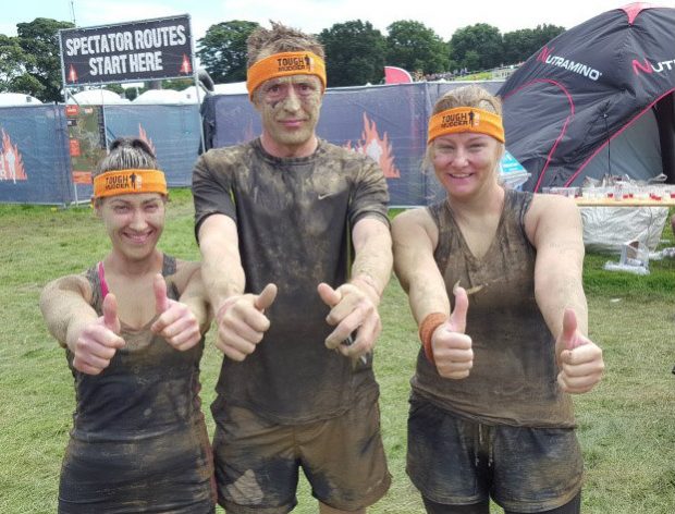 Thumbs up from three members of the Fylde Office team who took part in the Tough Mudder fundraising event.