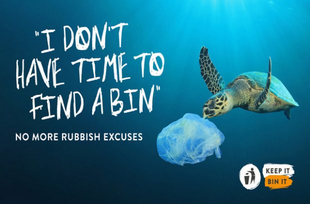 Image of a turtle eating a plastic bag in the ocean.
