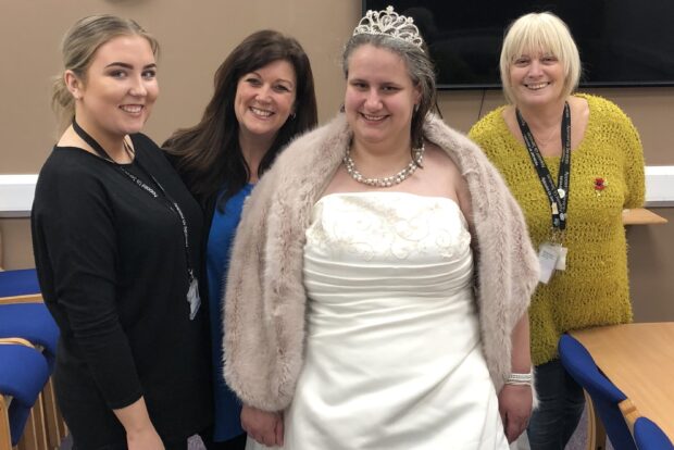 The team working with the bride to get her ready for the day