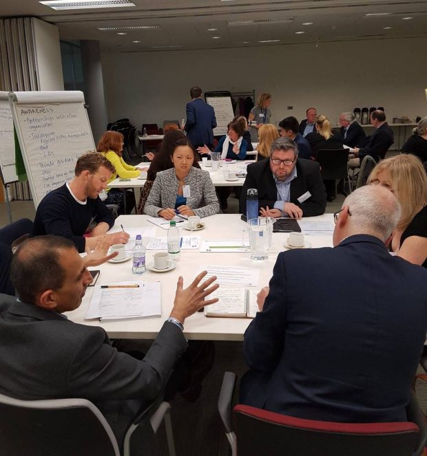 delegates at stakeholder event sitting at a table