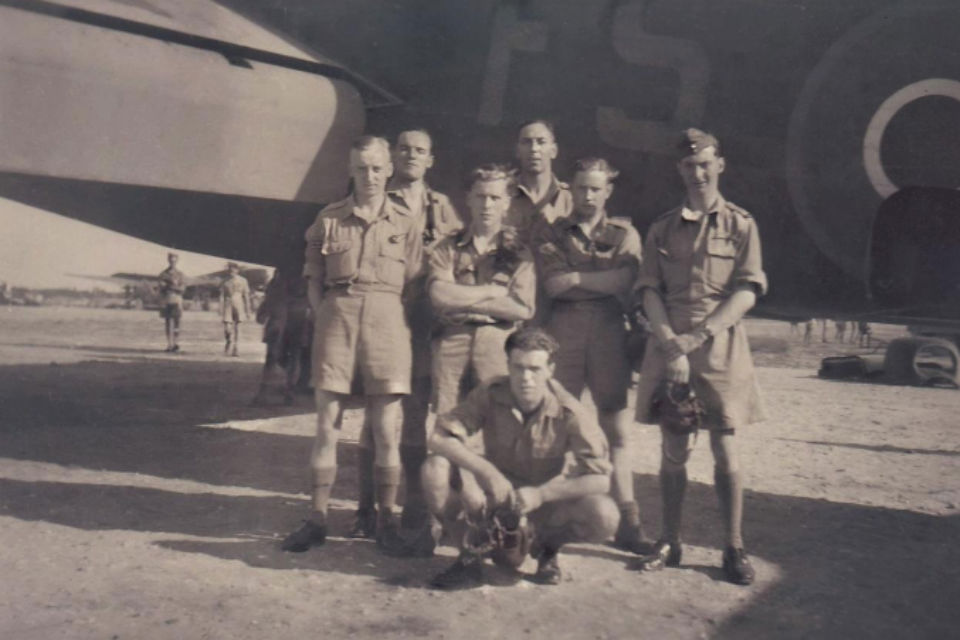 Britiish World War II air crew next to plane