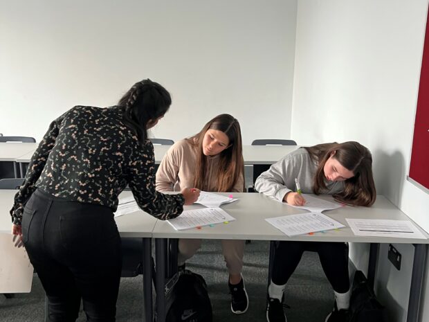 Sez Aydin tutoring pupils at Haileybury Turnford school
