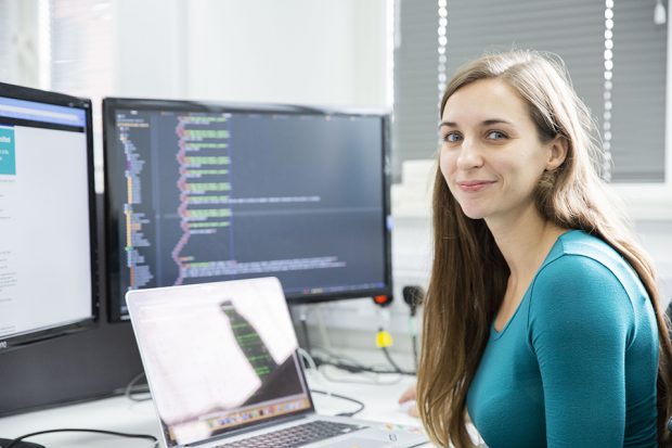 Digital apprentice Oceanne sat at a desk in Companies House.