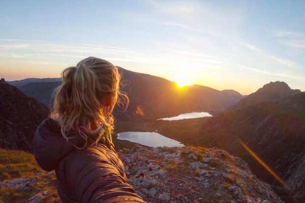Sarah looks at sunset from the mountain summit.