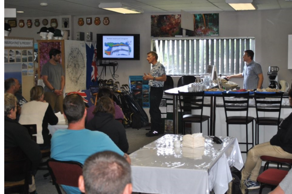 3 people presenting to a group of people