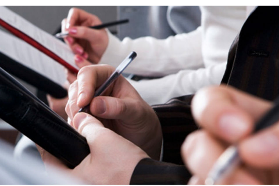 Picture of hands of students writing in notepads