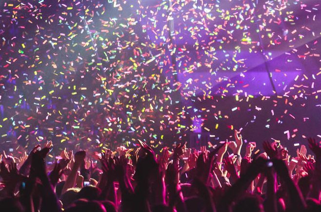 ticker tape celebration with women's hands reaching up
