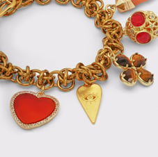 Katerina Psoma jewellery Statement gold chain bracelet with assorted charms embellished with stones in deep red tones.