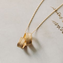 A gold pendant necklace. Emma Calvert