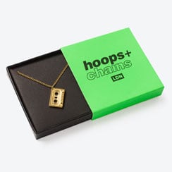 Hoops & Chains jewellery Gold cassette tape pendant necklace in a bright green gift box.