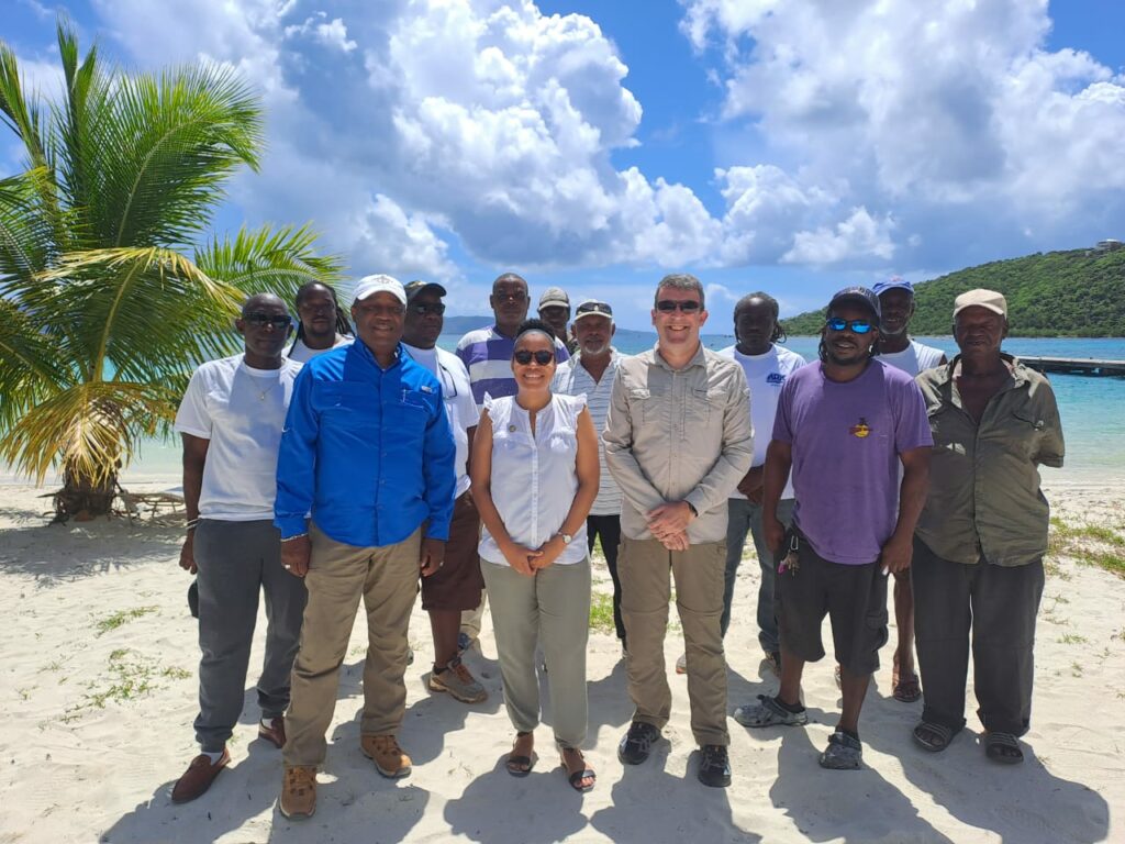 a group of fisher folk and stakeholders on the beach