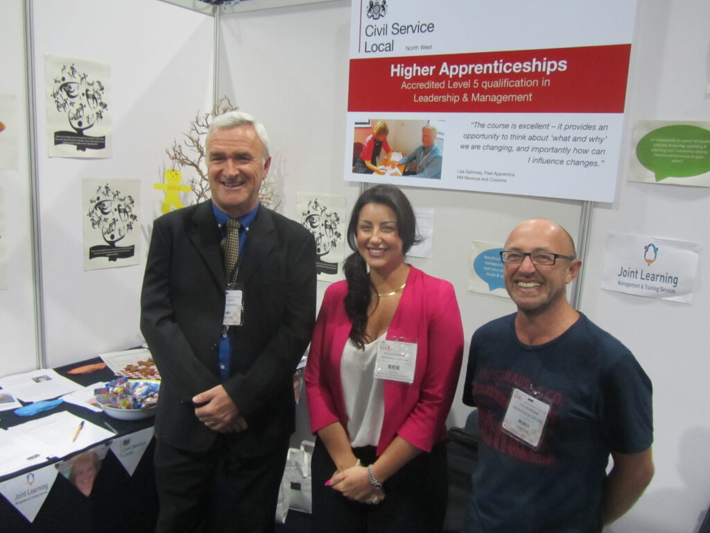 Smiling volunteers at apprenticeship stall