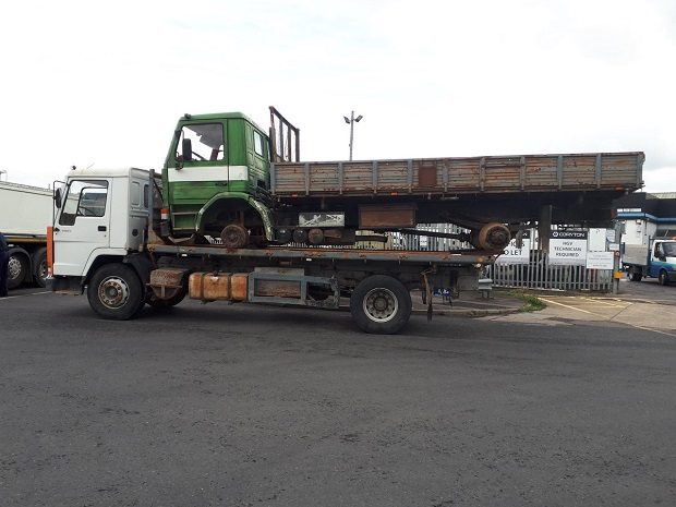 Overloaded truck carrying another truck