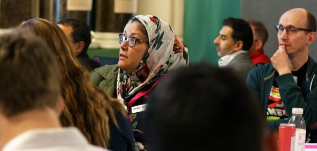 A person participating in a local event about public services