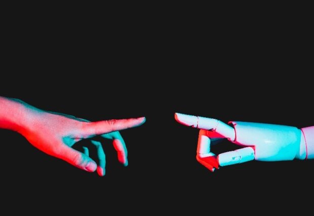 A human hand and a robot hand reaching towards each other