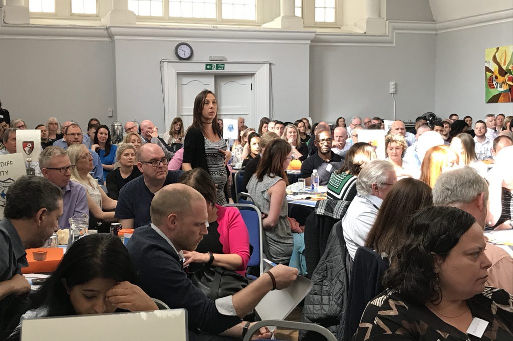 Samantha Taylor standing up at a conference asking a question