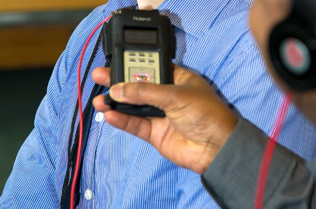 A hand holding a radio mike.