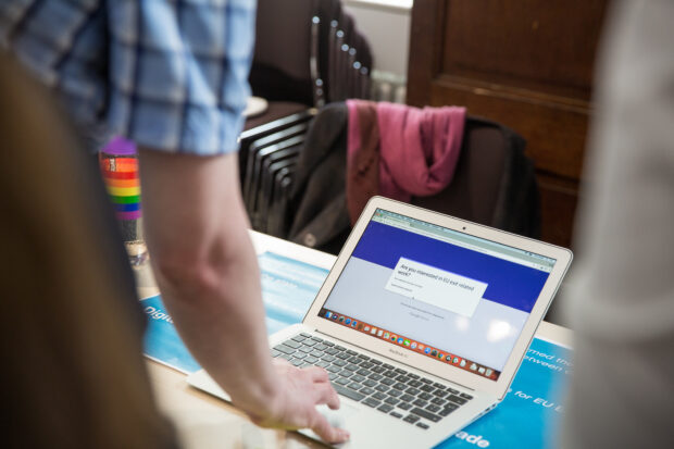 Someone using a laptop to input details
