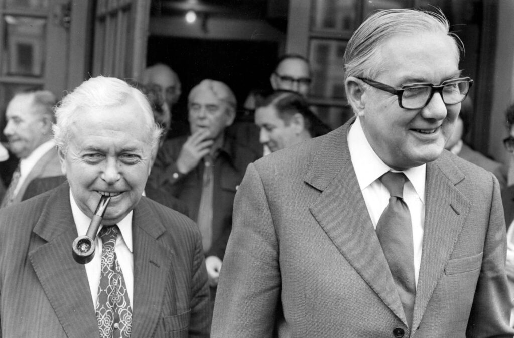 Prime Minister Harold Wilson with James Callaghan walking towards the camera. They both look happy
