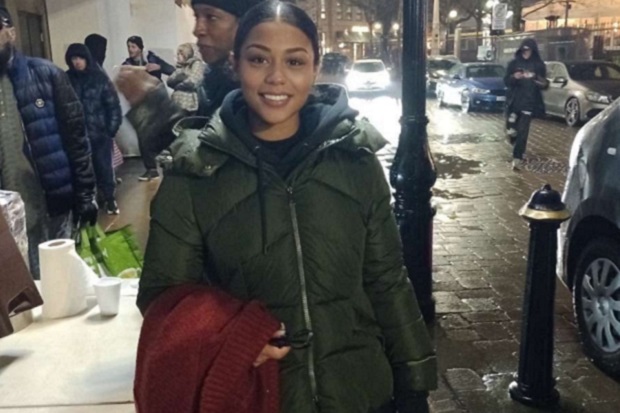 A girl in a green coat.