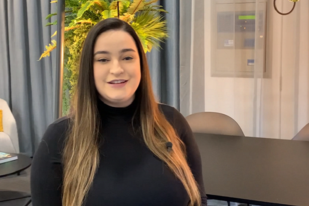 A lady in a black shirt, with long hair