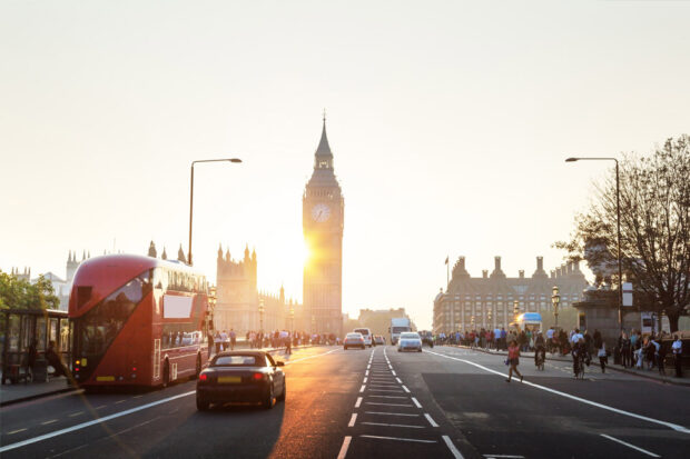 London road scene showing red bus and Big Ben