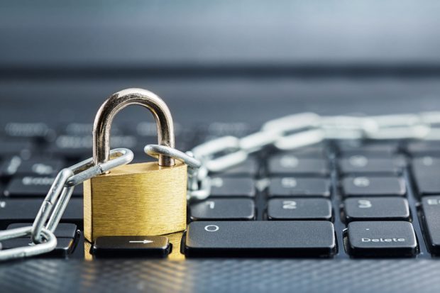 Padlock across computer keyboard.