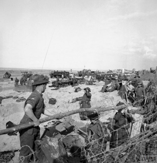 Troops digging in on a beach.