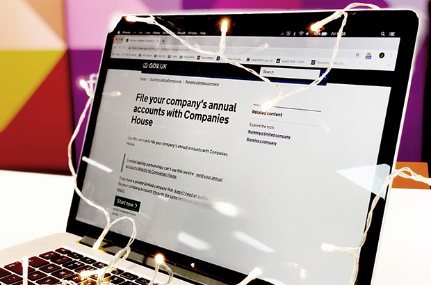 Laptop with Christmas lights on 'file your accounts with Companies House' webpage.