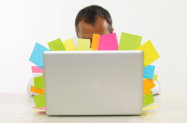 Computer covered in sticky notes