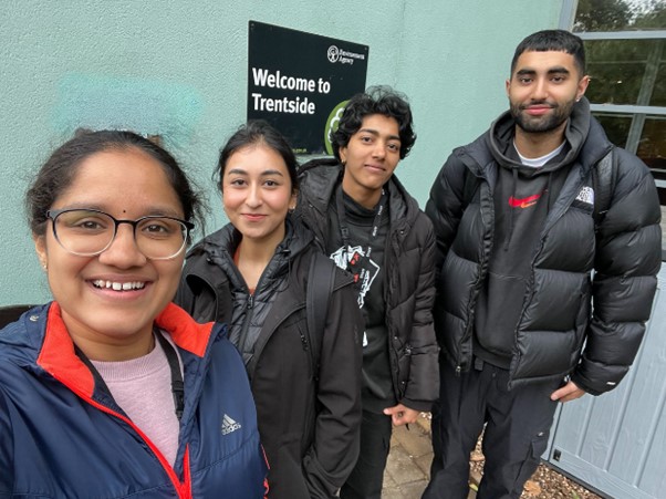 Four EA interns smile at the camera as they stand in front of the EA’s Trentside office in Nottingham.