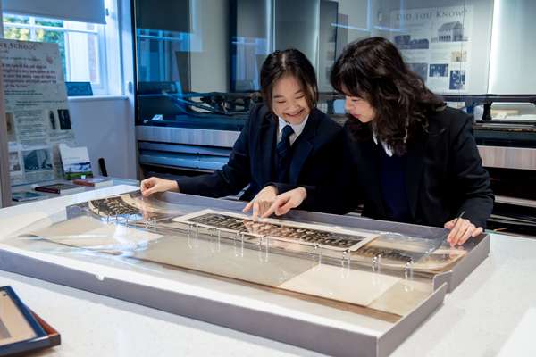 Two students looking at an image in a room