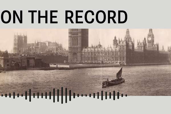 A historic photograph of the Houses of Parliament with the Thames in front.