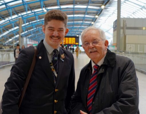 A photo of Mike and Andrew Lamport, smiling, at Waterloo Station