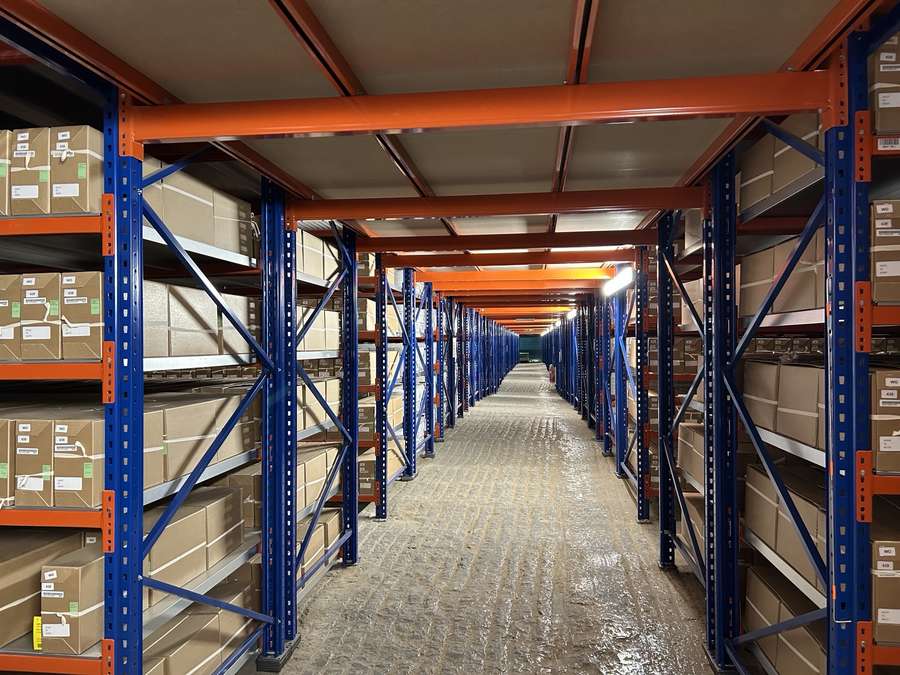 Rows and rows of metal shelves filled with archival boxes.