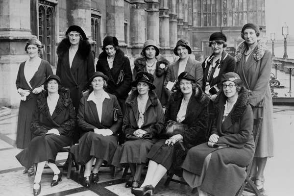 A black and white photo of female MPs sitting together.