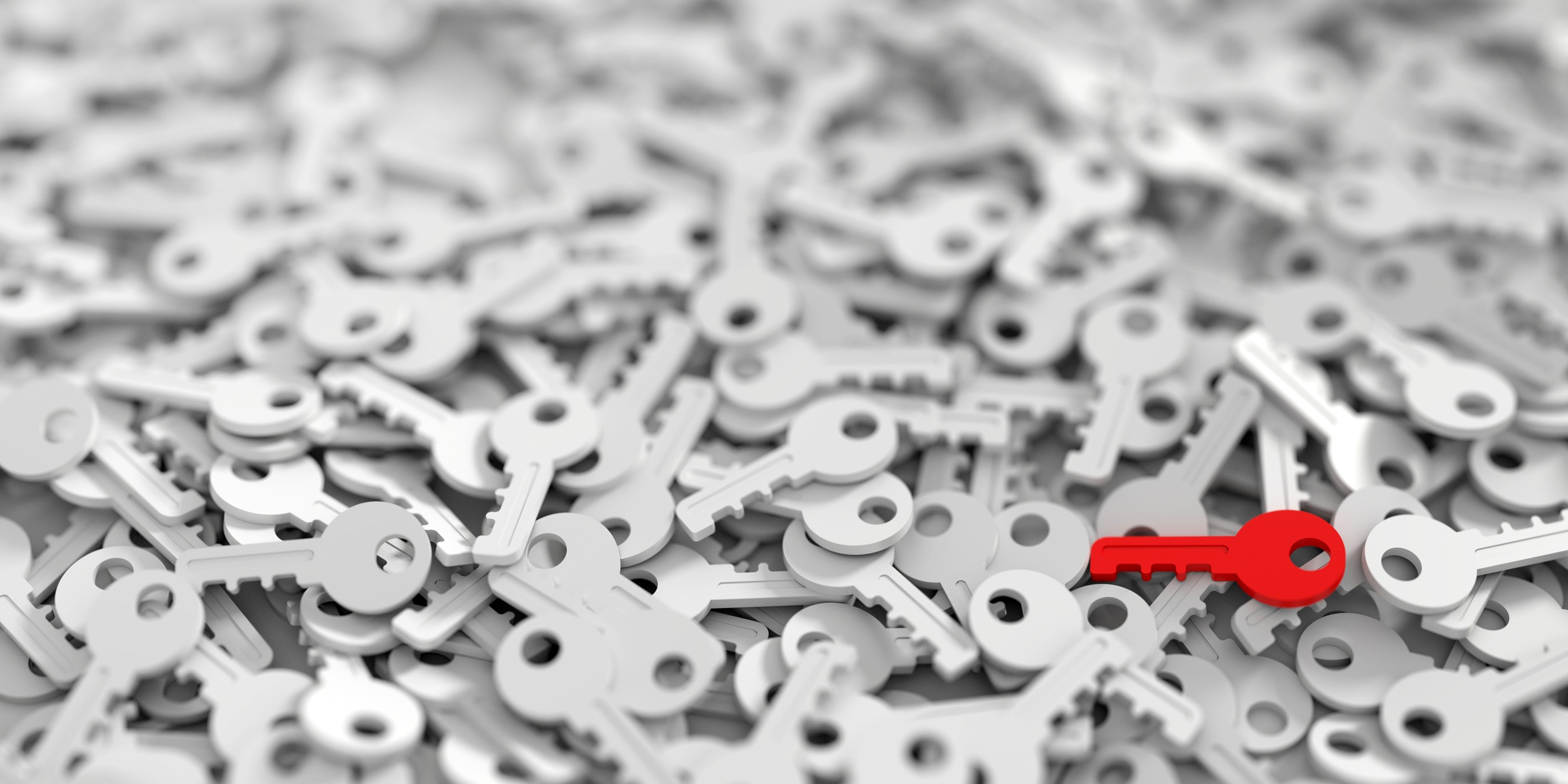 Huge pile of white keys, with a single red key on the top. Credit: Shutterstock.