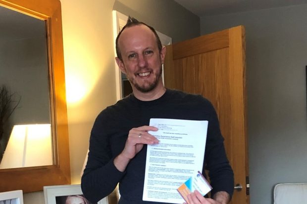 Matt Legg standing with his volunteering training certificate