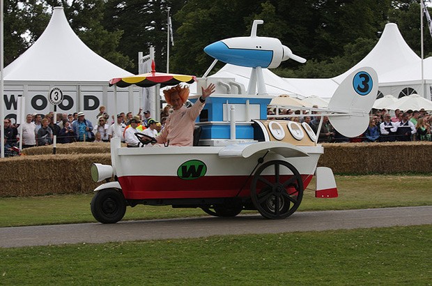 Photo of man dressed as Pat Pending driving a boat car