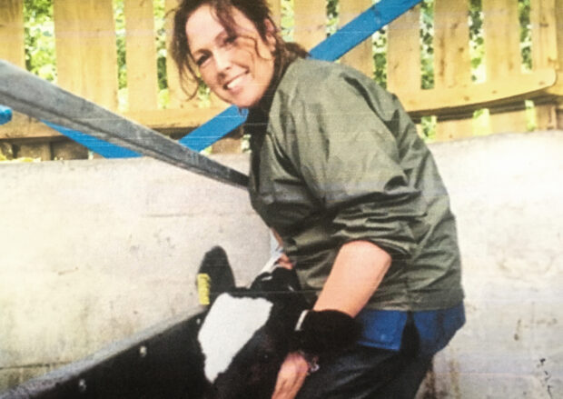 woman farmer with calf