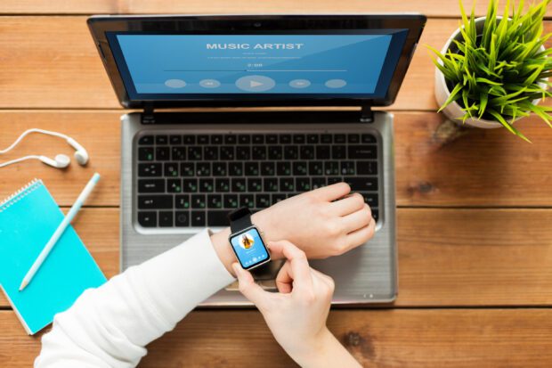 close up of person with smart watch and laptop
