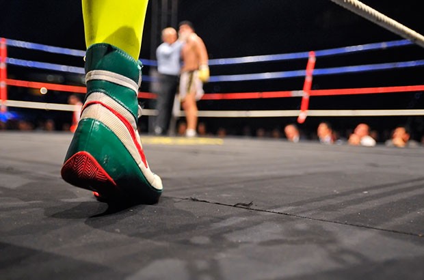 Image of a boxing ring and boxers feet.