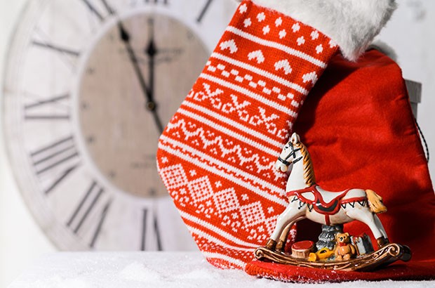 Image of a small china rocking horse and a Christmas stocking.