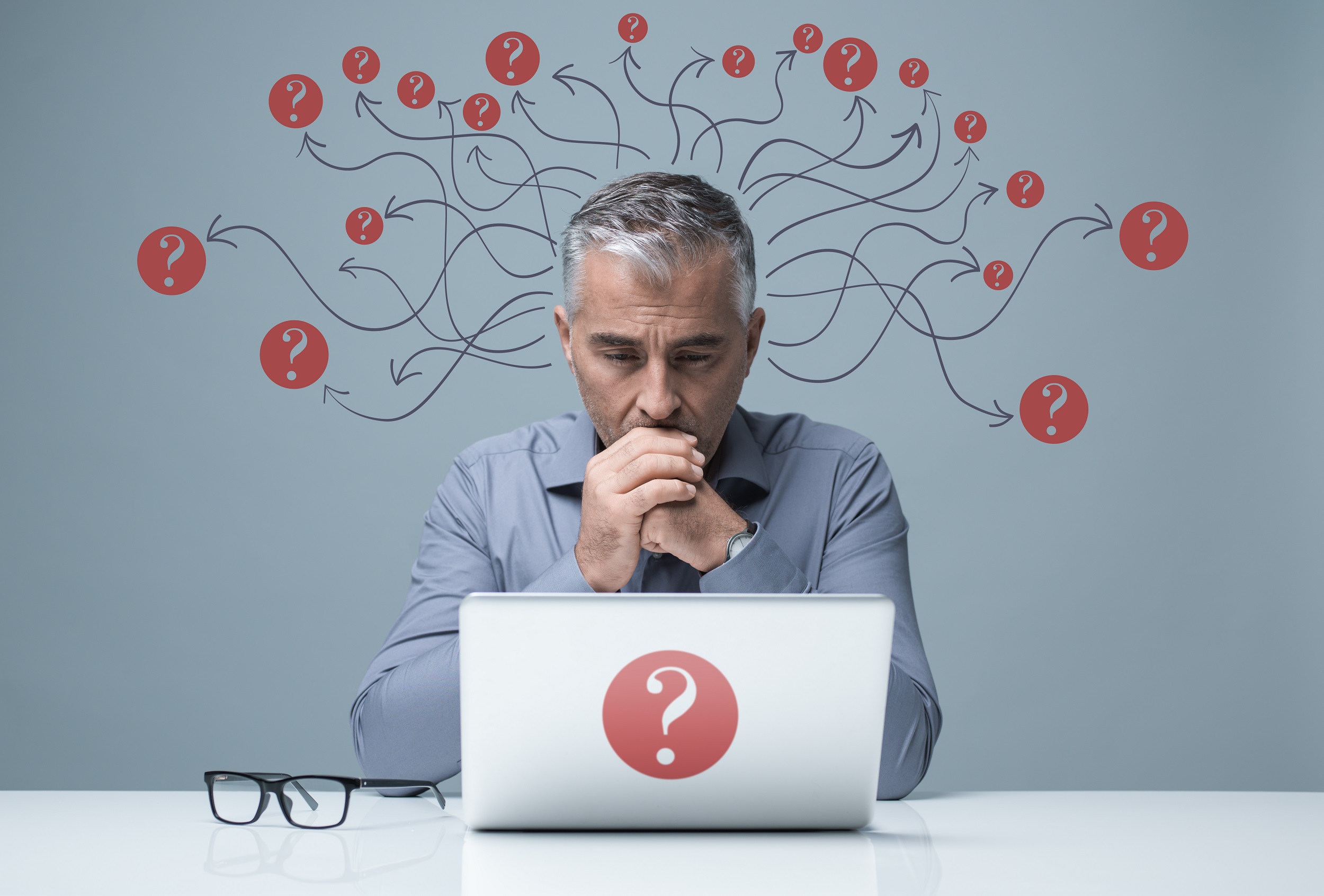 Pensive businessman at laptop.