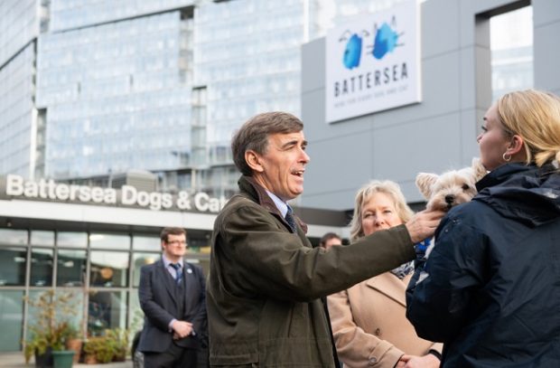 Minister Rutley speaking to a group of people outside Battersea Dogs and Cats Home.