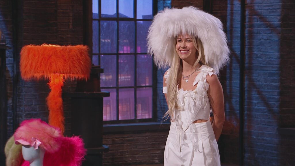 An image of Chloe Messer, donning a large white fluffy hat.
