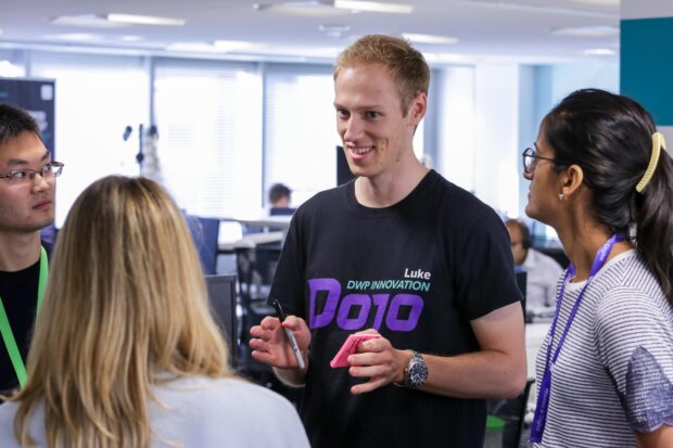 Dojo colleagues discusiing issues during the daily stand-up