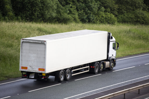 A white lorry travelling on the highway